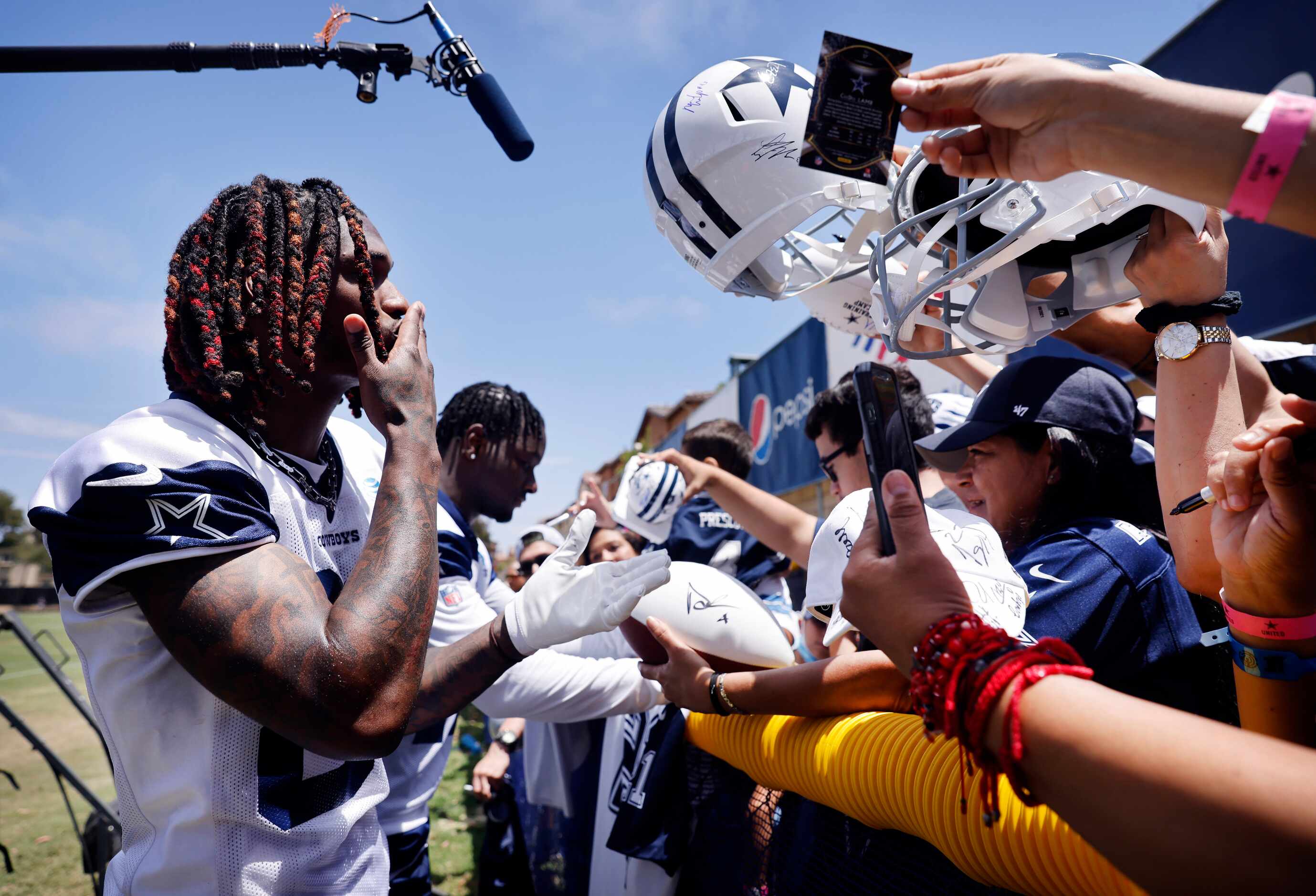 Dallas Cowboys wide receiver CeeDee Lamb (88) blows a kiss to fans after signing autographs...