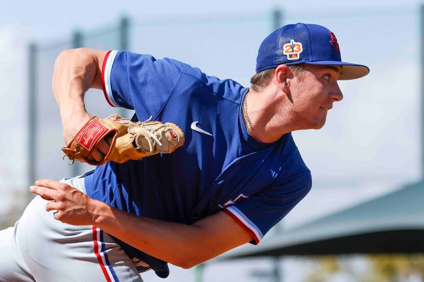 Texas Rangers minor league Mitch Bratt throws a pitch in the bullpen during a spring...