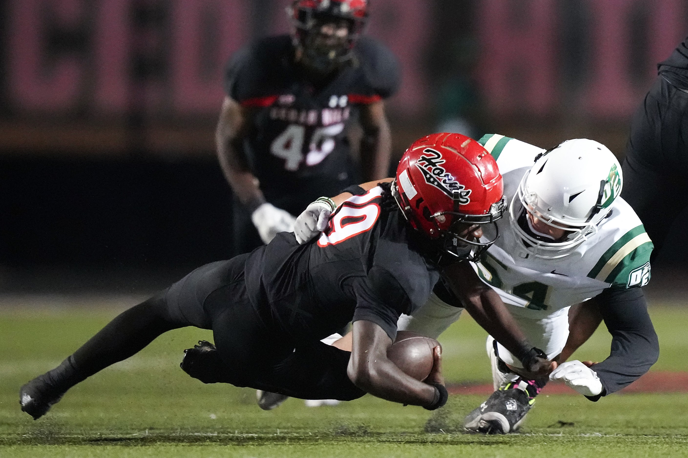 Cedar Hill quarterback Omowale Muhammid (19) is sacked by DeSoto defensive lineman Guilian...