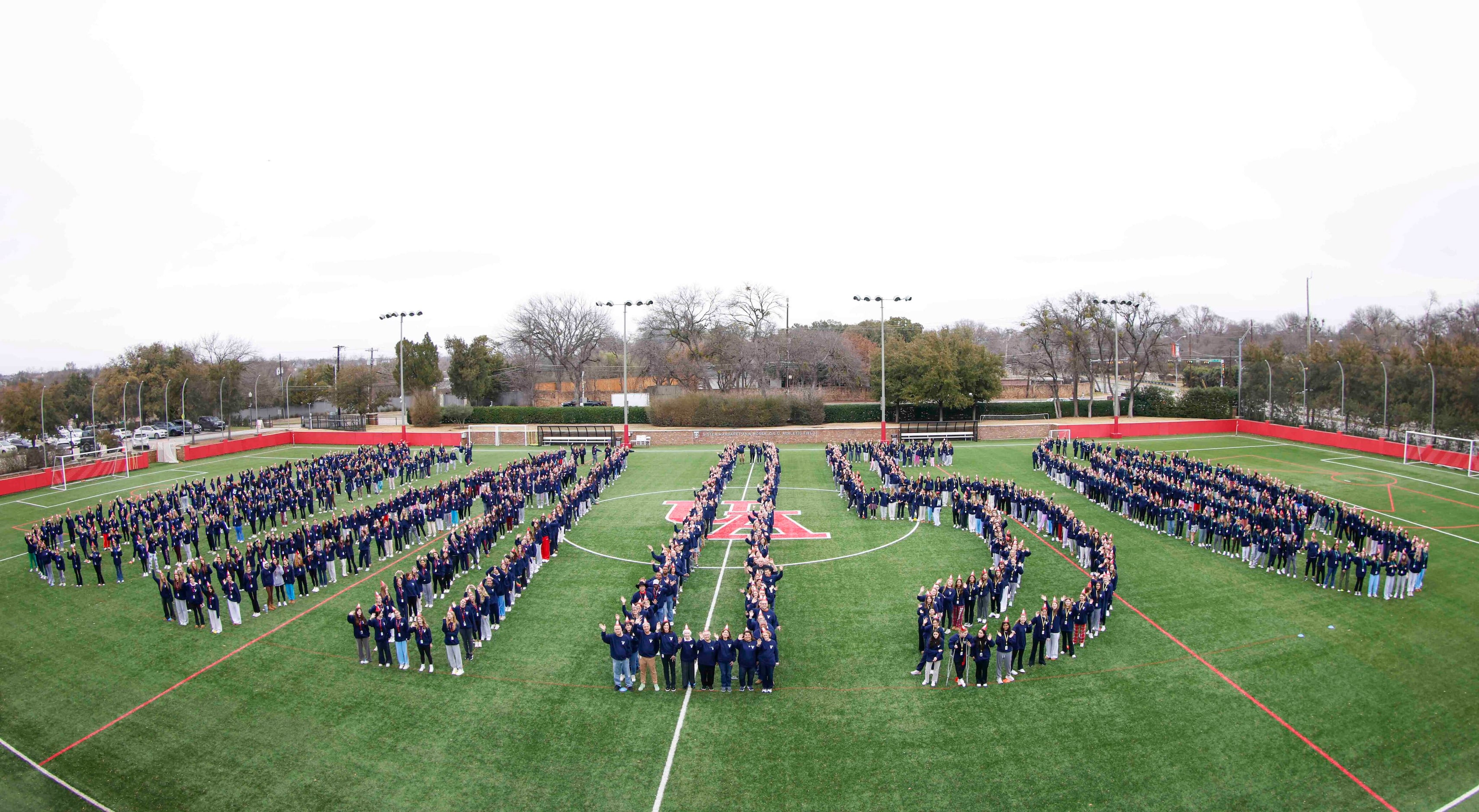 Students and faculty stand in formation of "UA 150" for a giant group photo  During the...