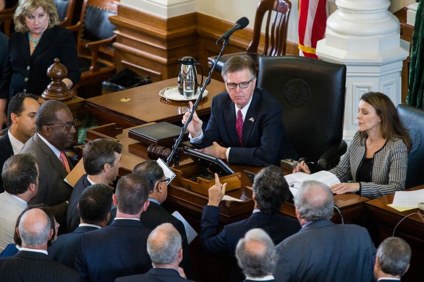 Senators argue  with Lt. Gov. Dan Patrick (center) and parliamentarian Karina Casari Davis...