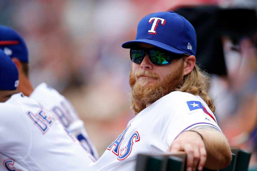 Injured Texas Rangers starting pitcher Andrew Cashner is pictured on the bench during a game...
