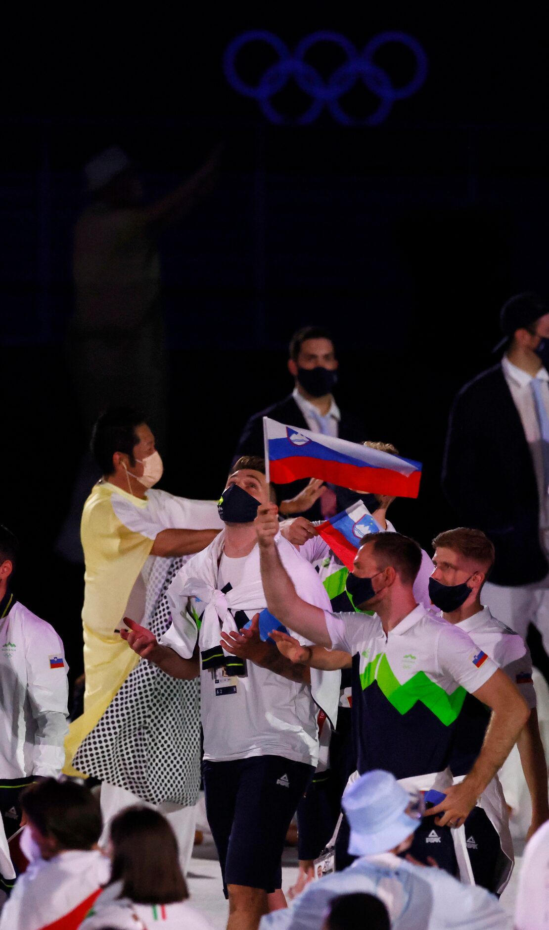 Slovenia’s Luka Doncic and other Olympic athletes from Slovenia make their way across the...