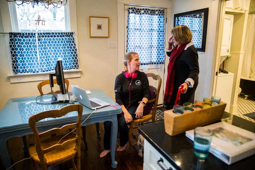 Sharla Elizalde (left) of Austin talks with AirBnb owner Kathi Chandler (right) as she works...