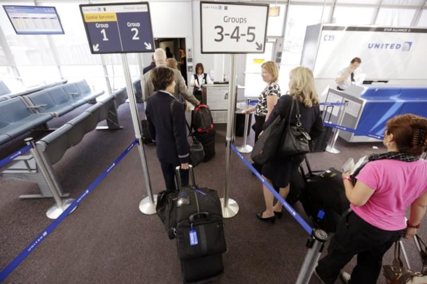 Passengers wait at a United Airlines gate at O’Hare International Airport. Travel expert...