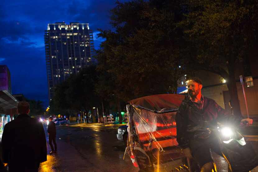 Pedicab driver David Ames calls out for rides to people passing by during SXSW in Austin,...
