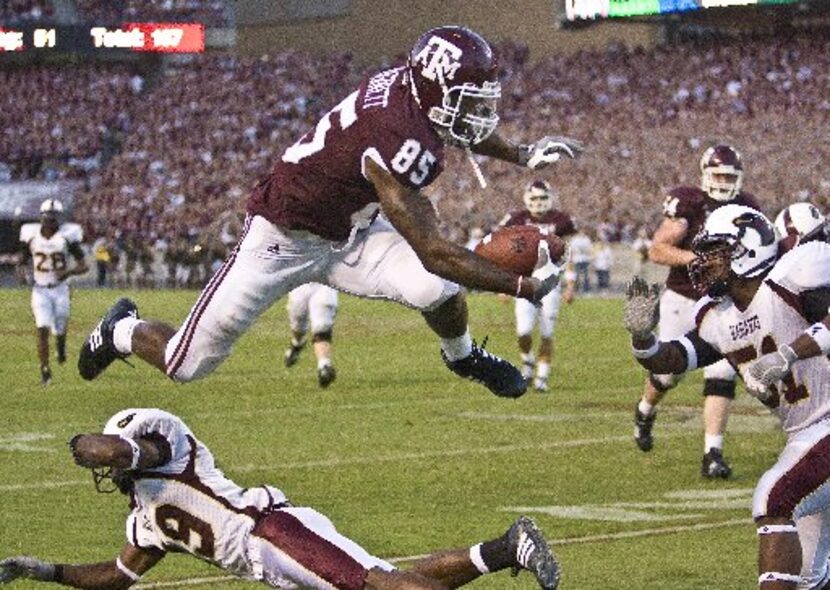 Texas A&M tight end Martellus Bennett (85) leaps over Louisiana-Monroe's Chance Payne (13)...