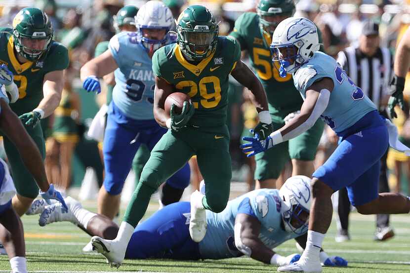 FILE - Baylor running back Richard Reese runs through the Kansas defense in the first half...