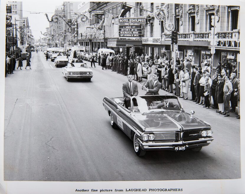 Dallas Texans defensive back Duane Wood and linebacker E.J. Holub (with horn) ride through...