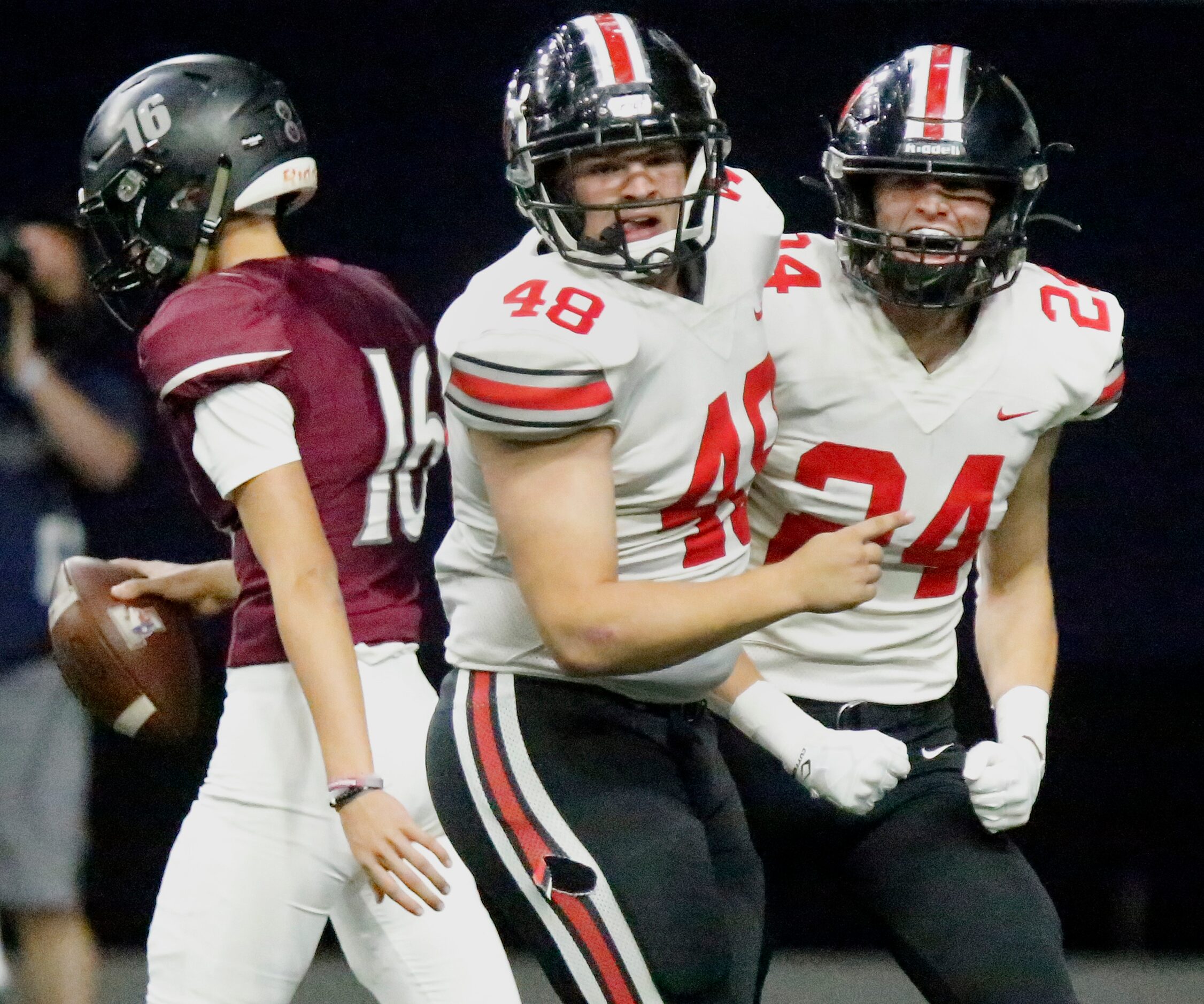 Lovejoy High School defensive lineman Brian Kotecki (48) congratulates defensive back Trent...