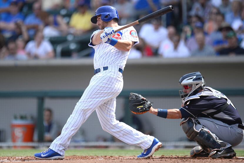 Chicago Cubs first baseman Mike Olt (30) follows through on a single in the first inning...