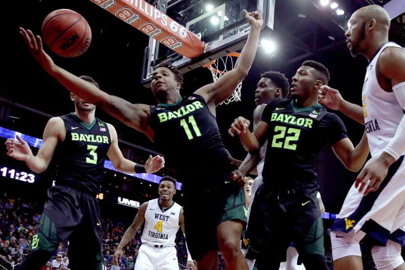 Baylor's Mark Vital (11) tries to keep the ball from going out of bounds during the second...