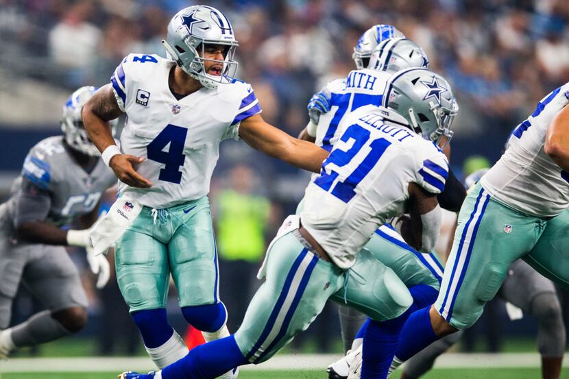 Dallas Cowboys quarterback Dak Prescott (4) hands off to running back Ezekiel Elliott (21)...