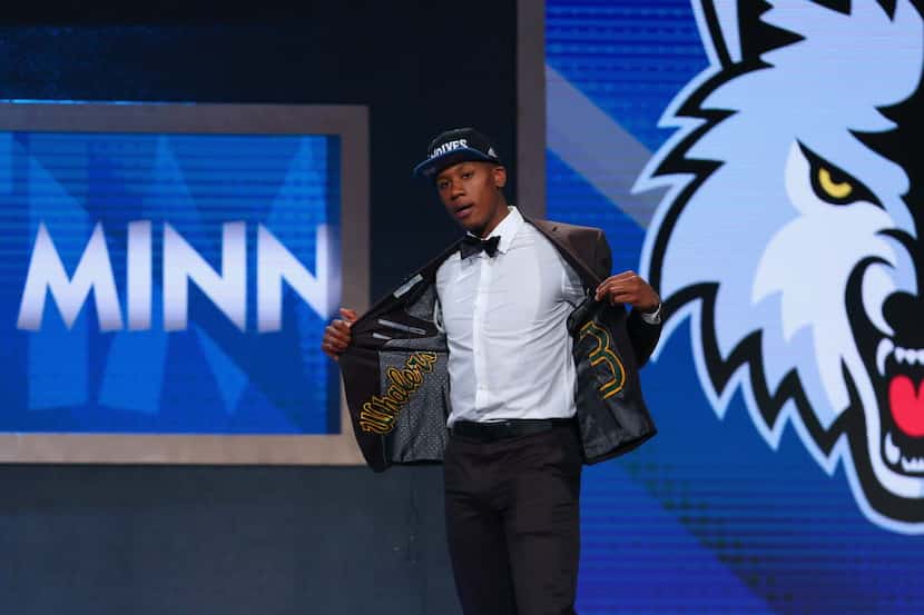 Kris Dunn walked on stage after being drafted fifth overall by the Minnesota Timberwolves in...