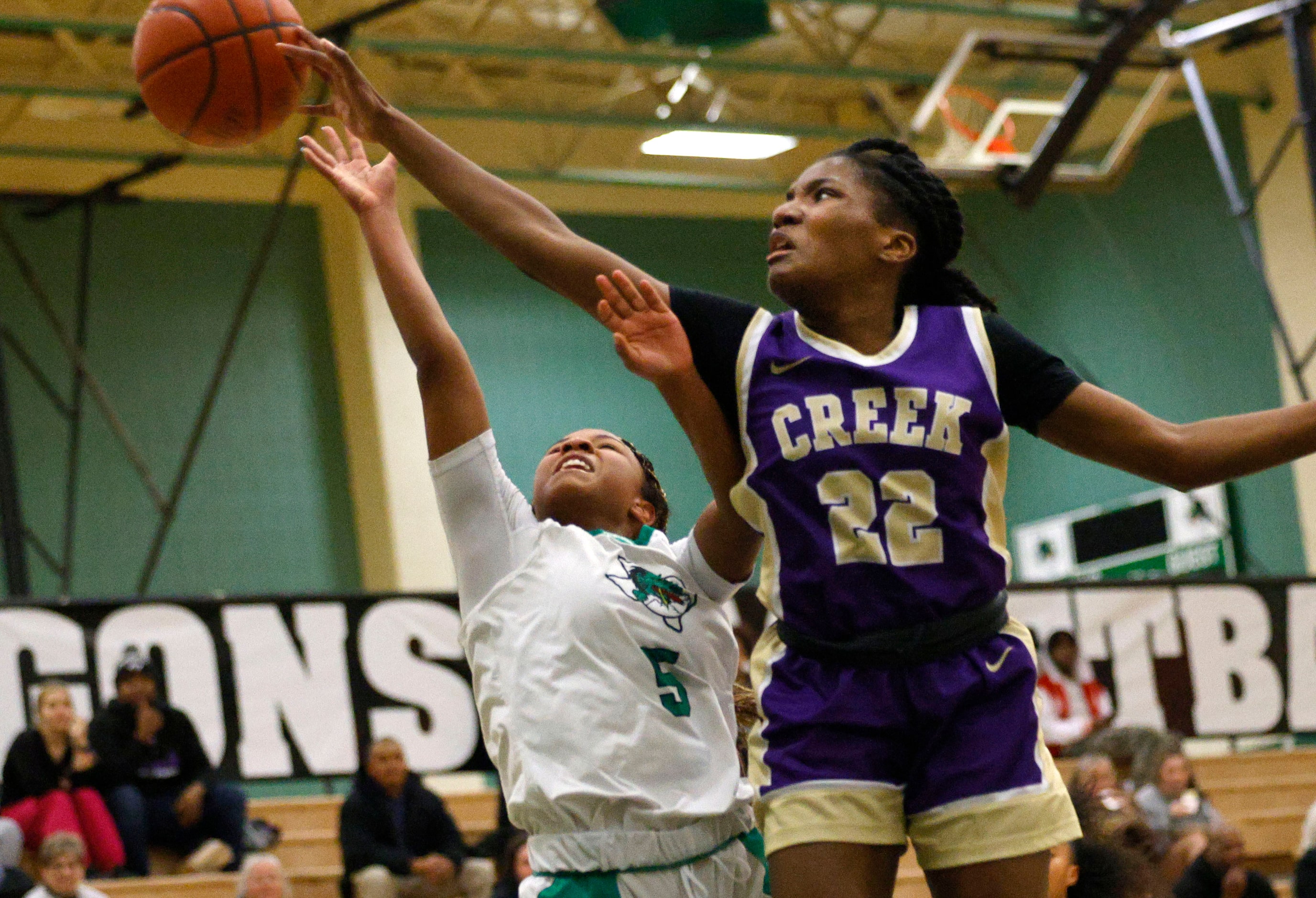 Keller Timber Creek's London Lumsden (22) defends as Southlake Carroll's Nadia Jordan (5)...