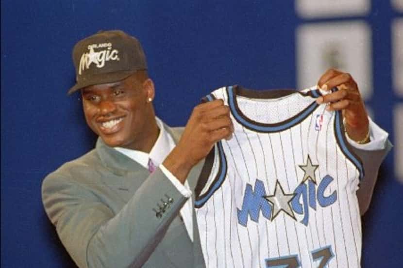 A happy Shaquille O' Neal from Louisiana State University holds up his Orlando Magic  jersey...