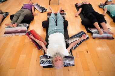 Vietnam veteran Joshua Lloyd, 73, center, practices iRest, a guided meditation experience,...