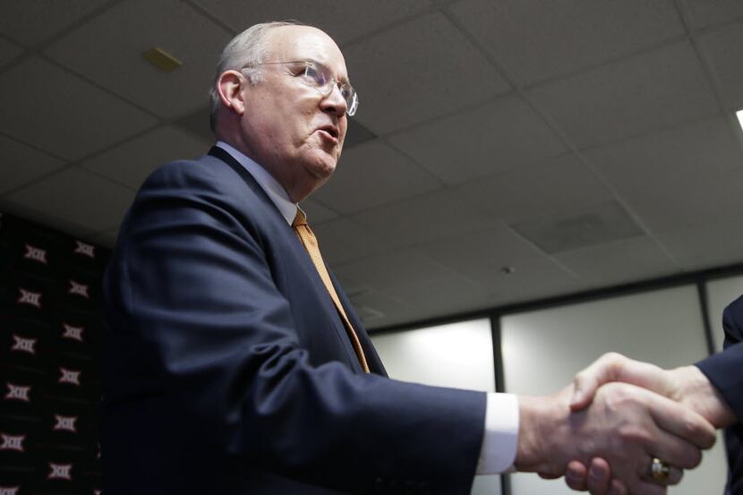 Texas Athletic Director Mike Perrin shakes hands after the Big 12 conference meeting...