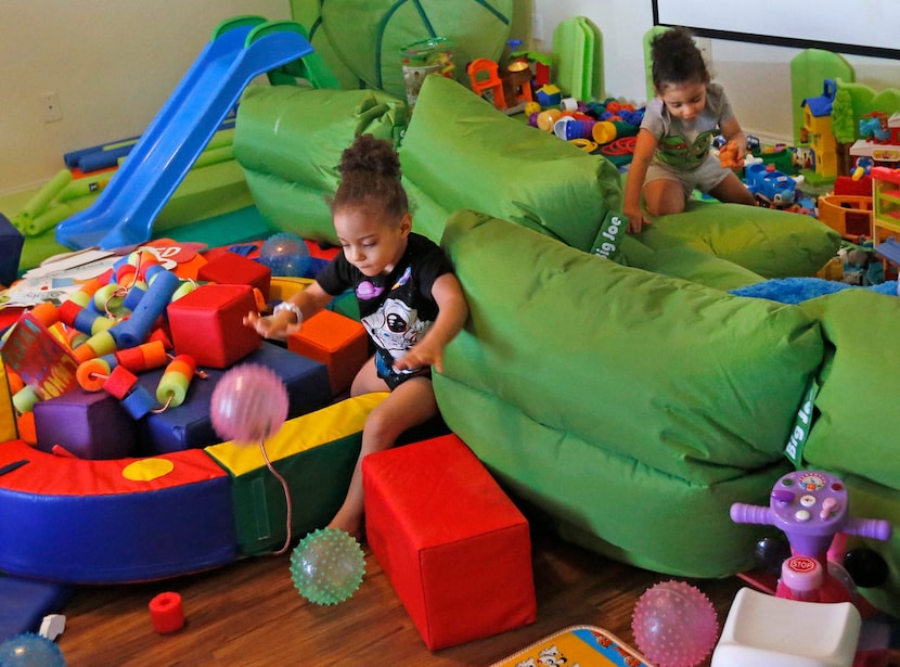 Dallas Wings' player Glory Johnson's twin daughters Ava, left, and Solei play with their...