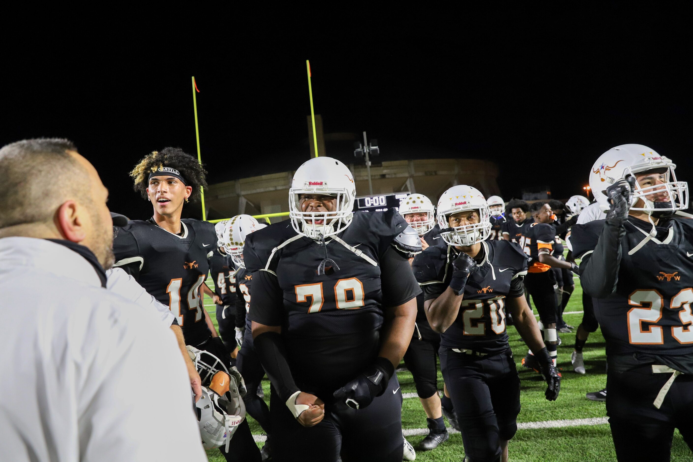 W.T. White head coach Tony Johnson celebrates with his team after a win against Bryan Adams...