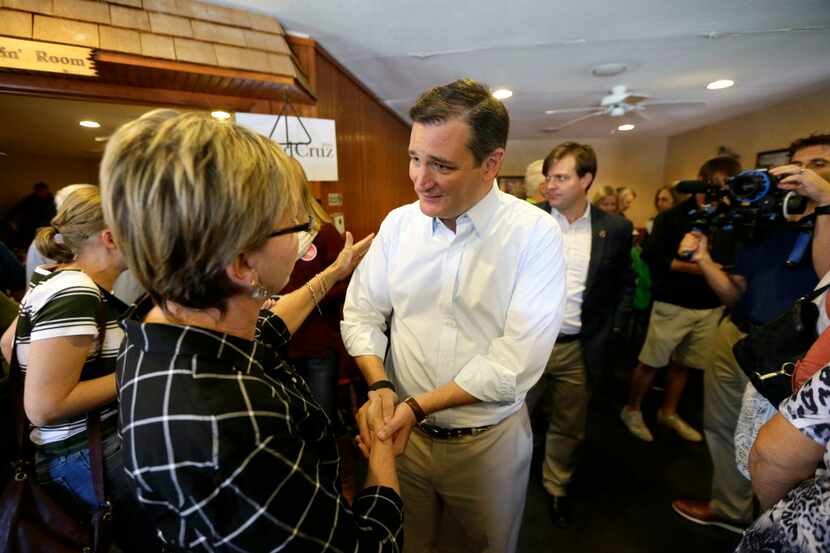  Sen. Ted Cruz talks with an audience member during a campaign stop, Monday, Oct. 12, 2015,...