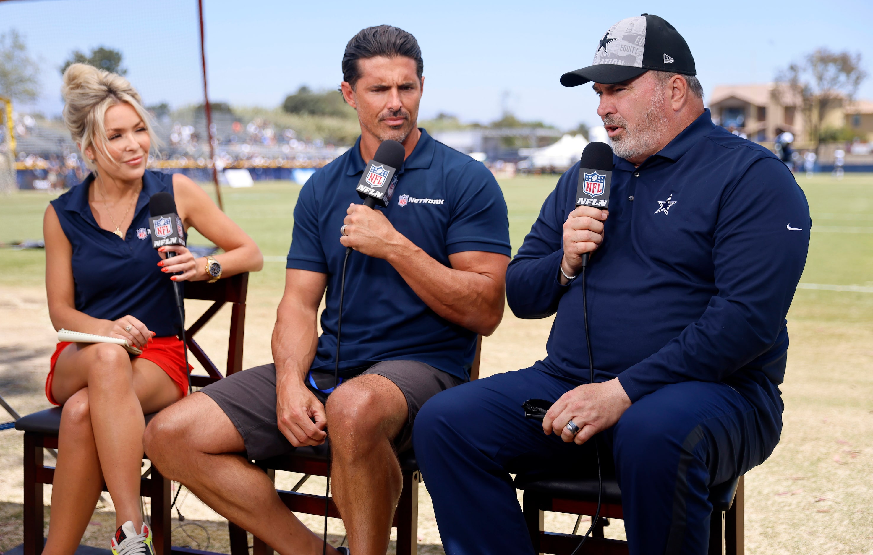 Dallas Cowboys head coach Mike McCarthy  (right) visits with NFL Networks David Carr and...