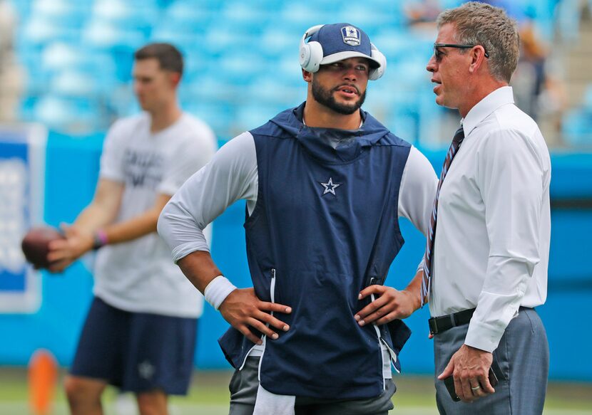 Dallas Cowboys quarterback Dak Prescott (4) talks with TV analyst troy Aikman before the...