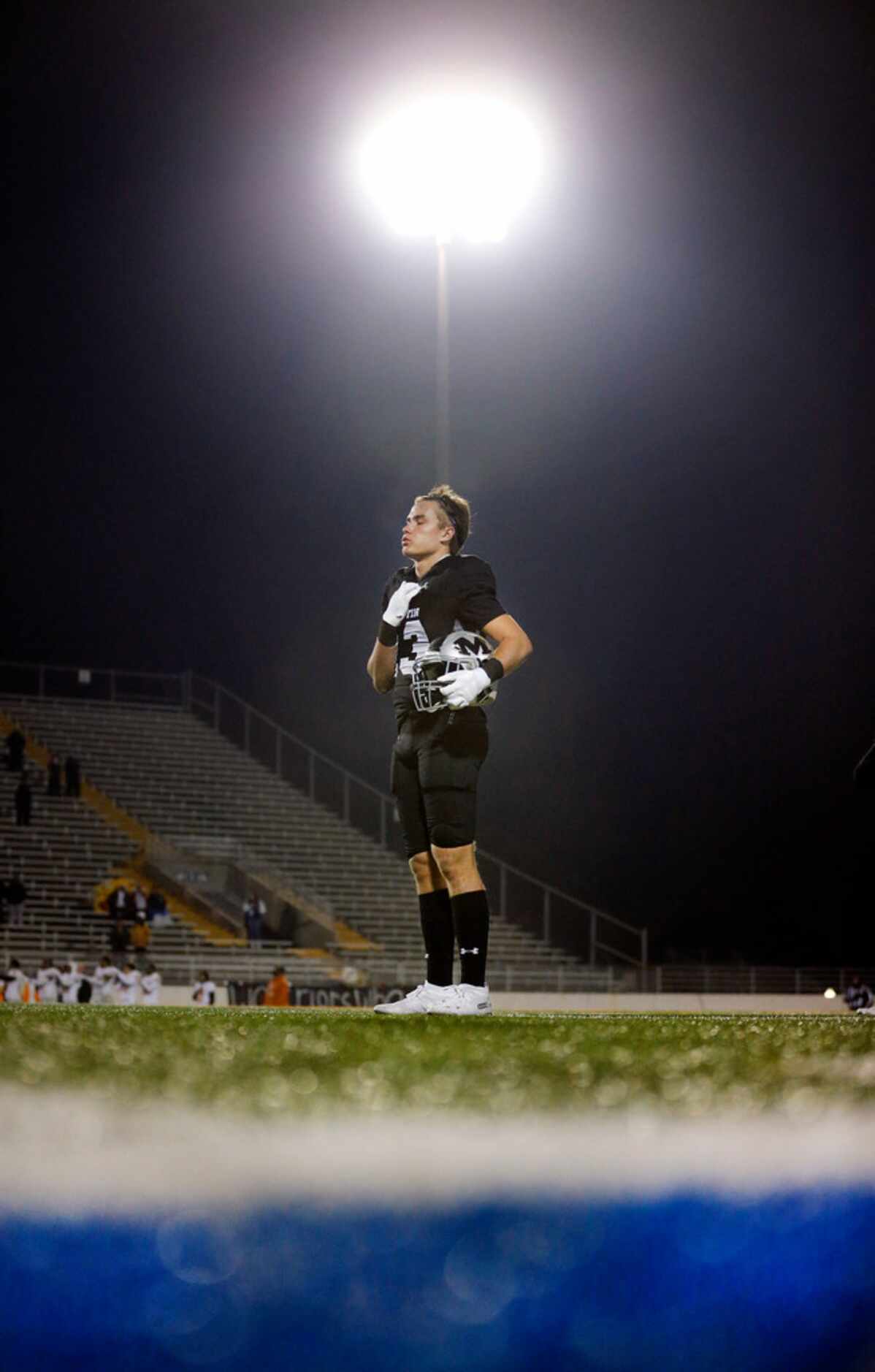 Martin receiver Cal Robinson (13) stands for the national anthem before facing Bowie at...