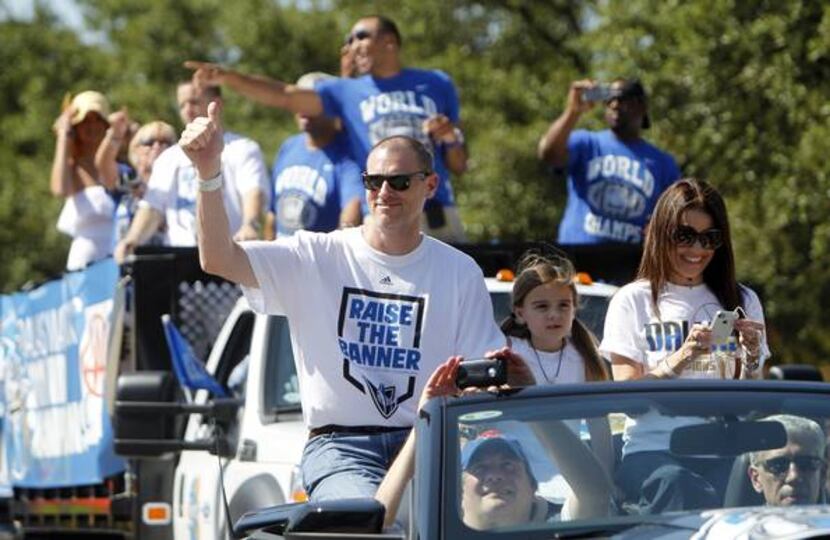 Dallas Mavericks head coach Rick Carlisle and family wave to the crowd during the 2011...