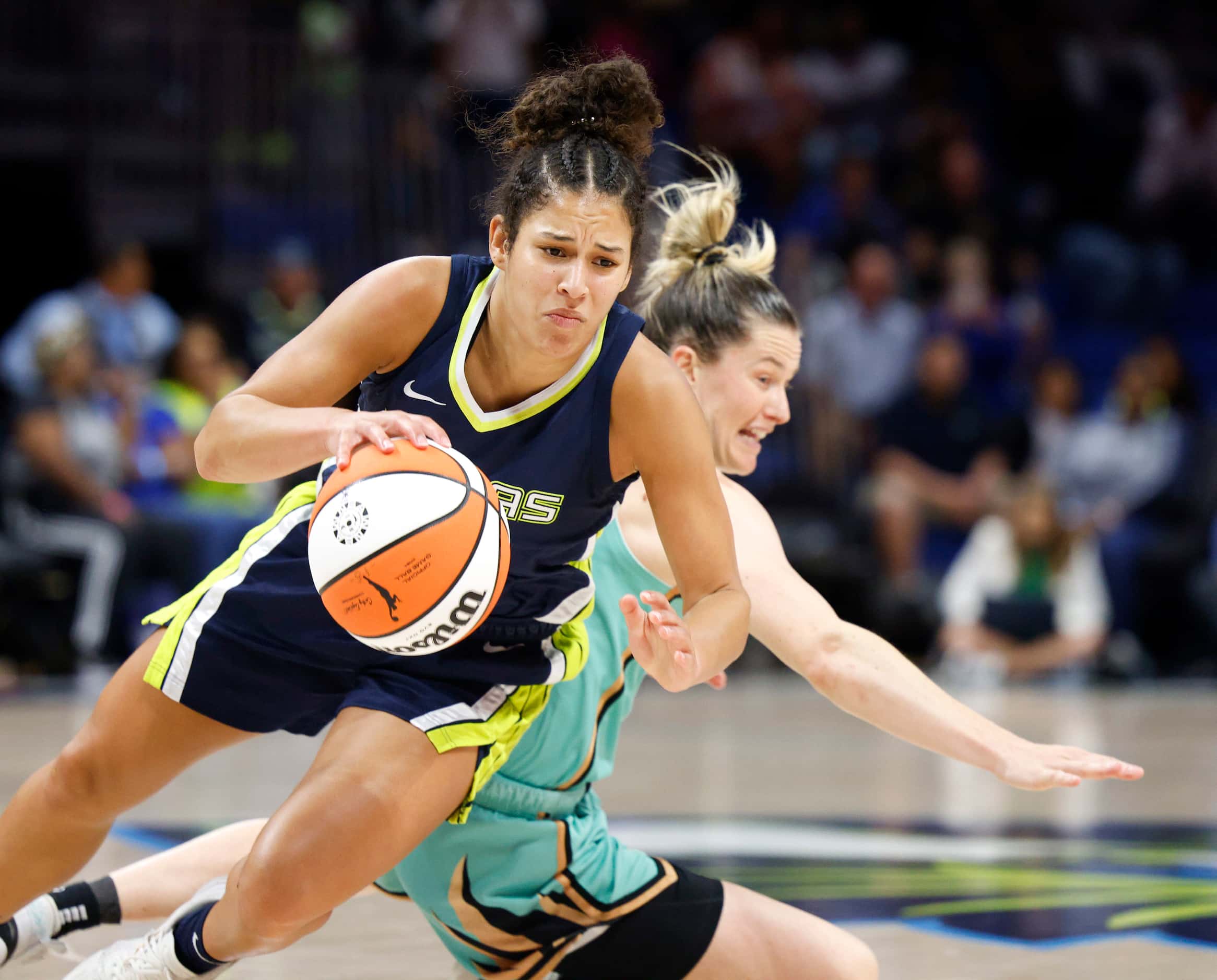 Dallas Wings guard Veronica Burton (12) falls to the ground after colliding with New York...