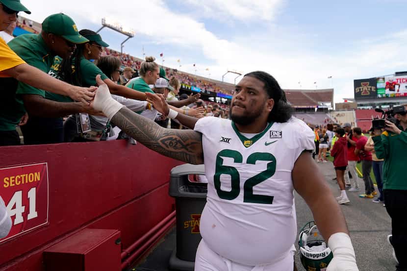 Baylor defensive lineman Siaki Ika (62) celebrates with fans after an NCAA college football...