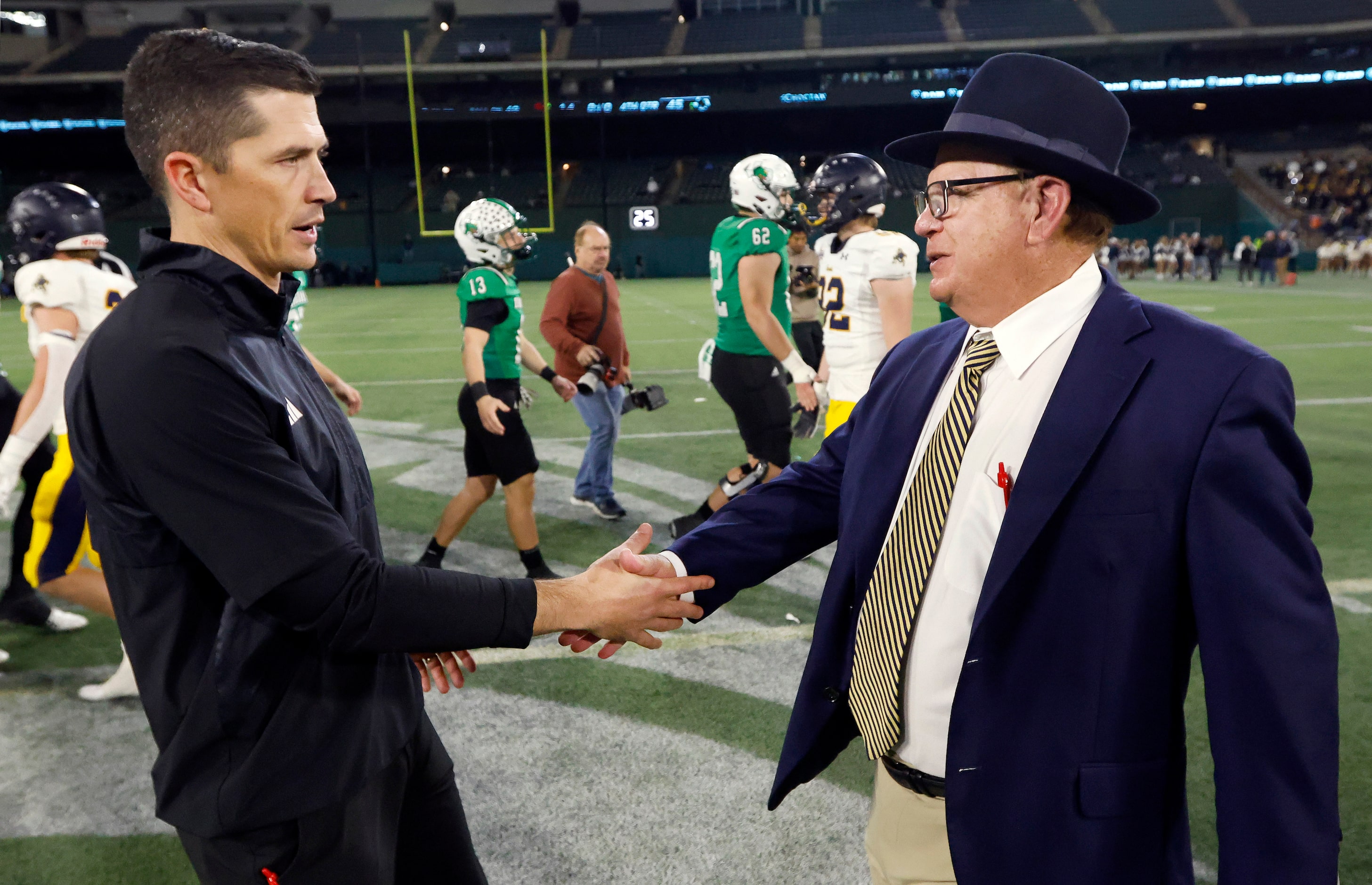 Southlake Carroll head coach Riley Dodge (left) is congratulated on their win by Highland...