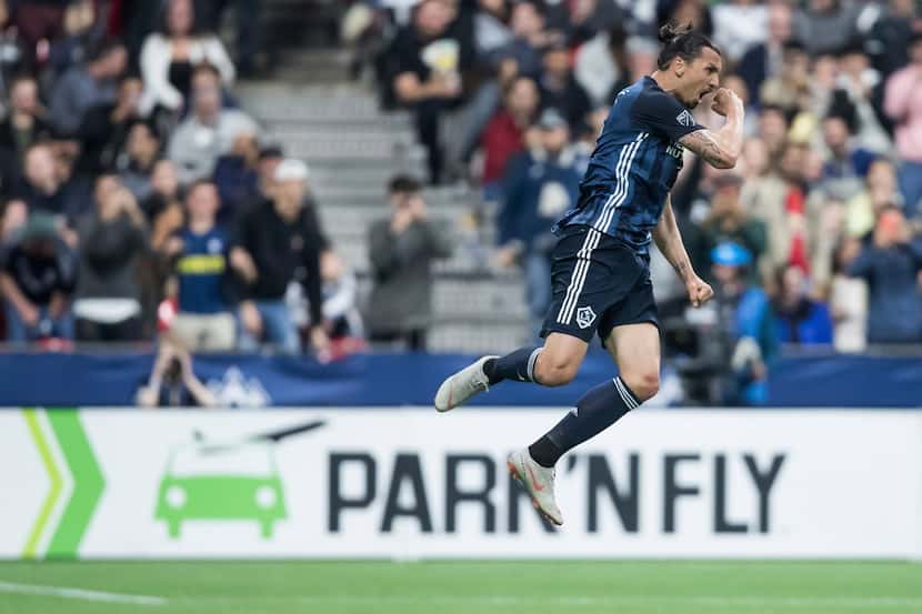 LA Galaxy's Zlatan Ibrahimovic celebrates after scoring a goal against the Vancouver...