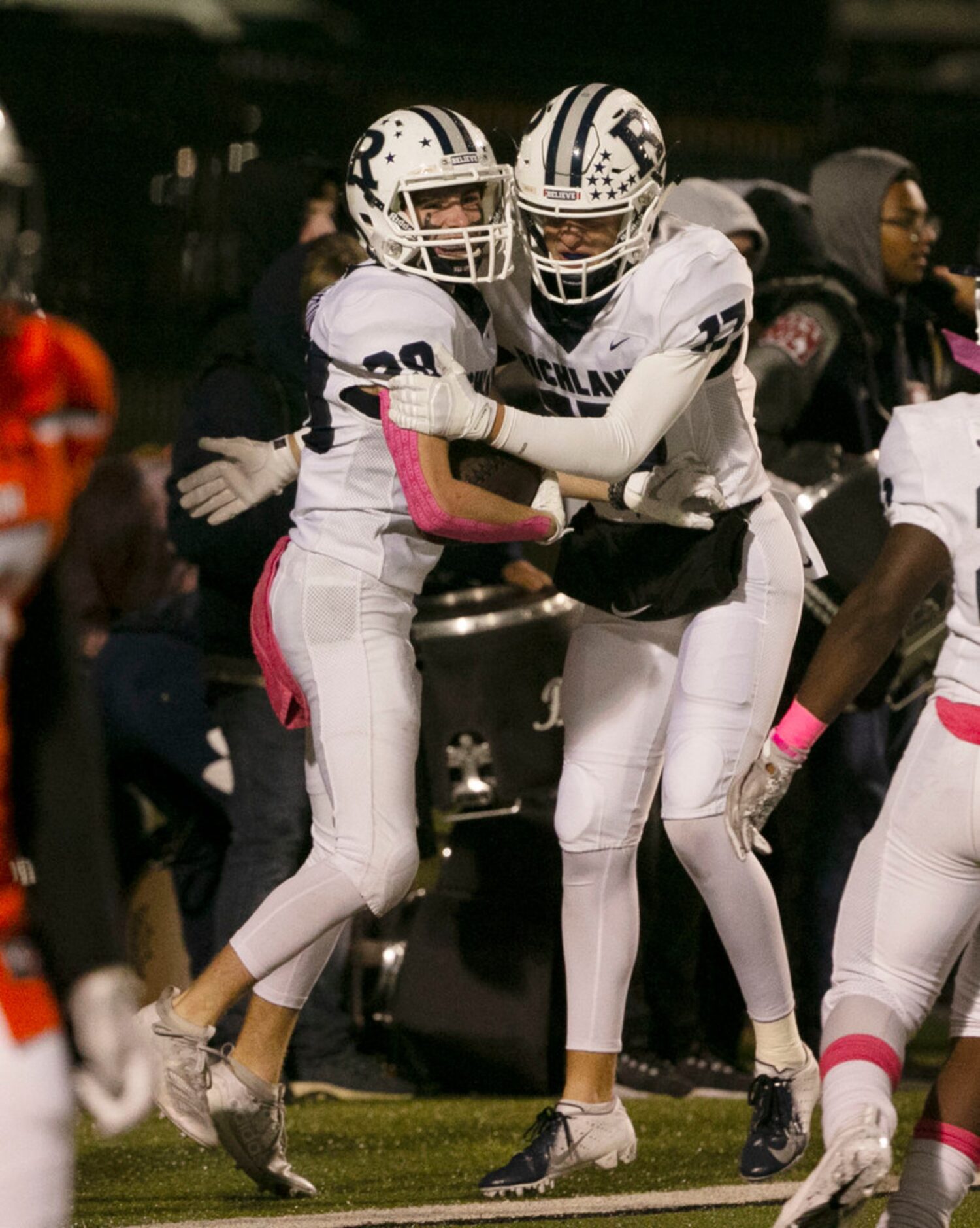 Richland's Slade Hamilton (20), left, celebrates his touchdown against Haltom with Seth...