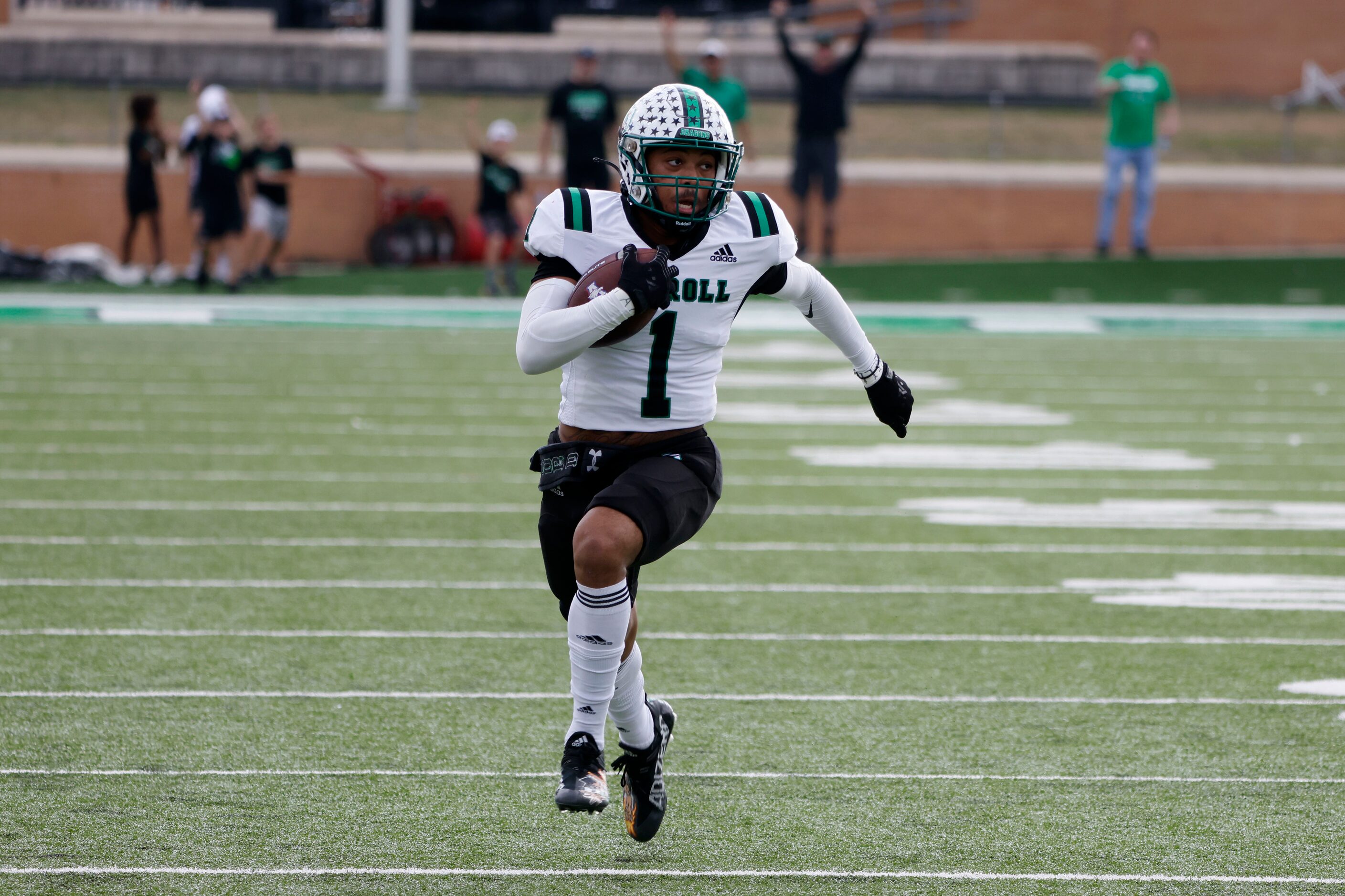 Southlake Carroll defender Avyonne Jones (1) runs an interception back for a touchdown...