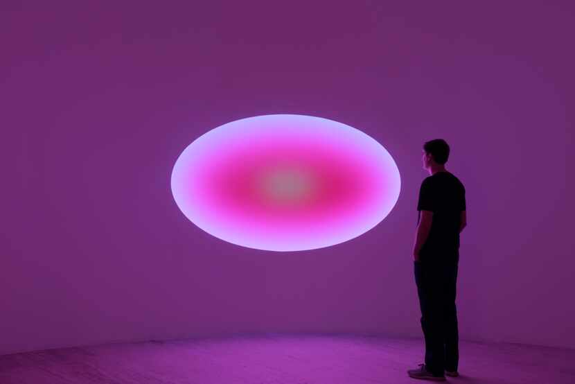 A visitor checks out James Turrell's "Curved Elliptical Glass," a 2019 work.