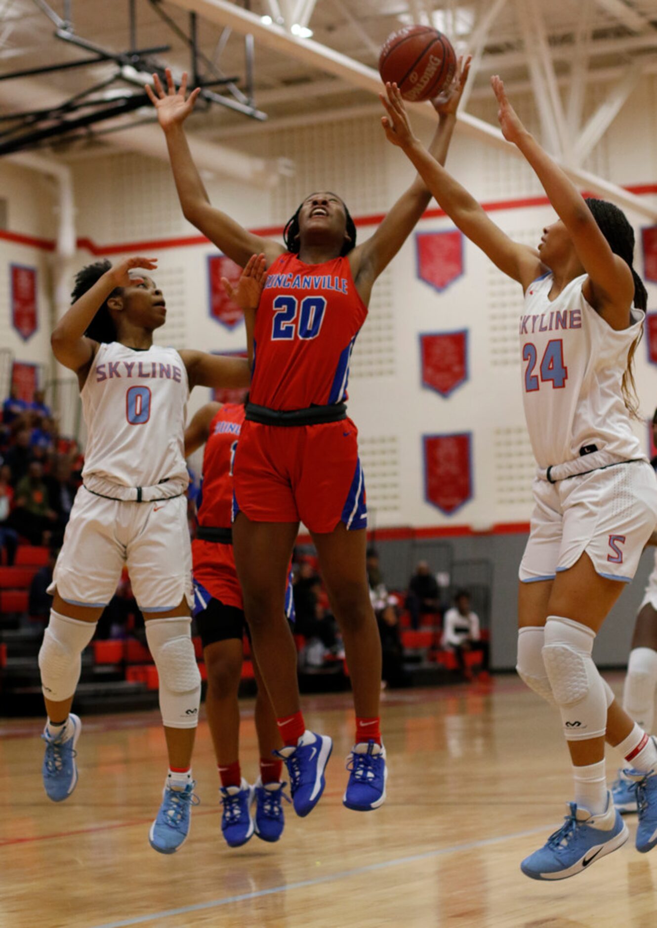 Duncanville's Anaya Bernard (20) battles Dallas Skyline's Zyniah Thomas (0) and Franchesca...