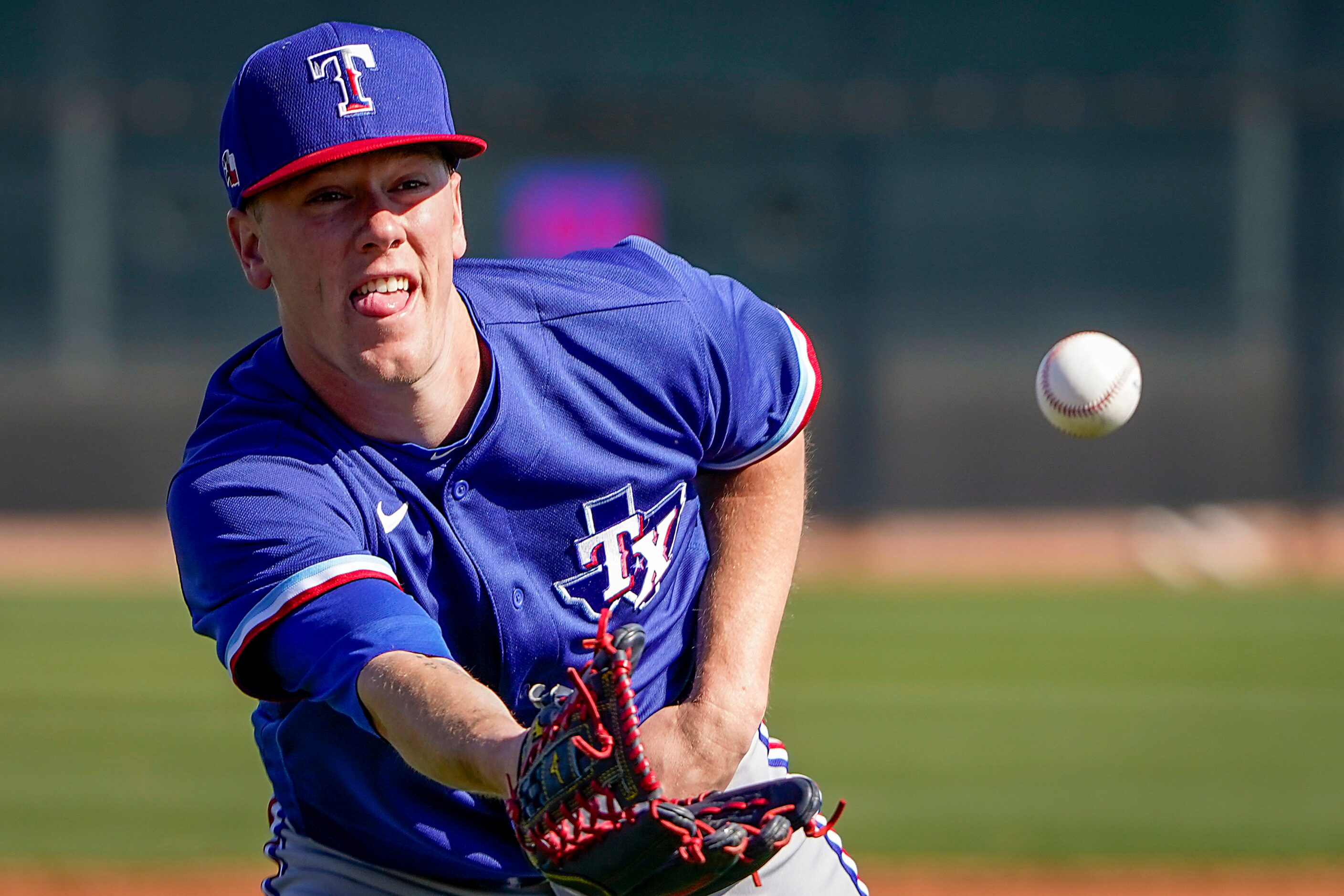 Texas Rangers pitcher Kolby Allard participates in a fielding drill during a training...