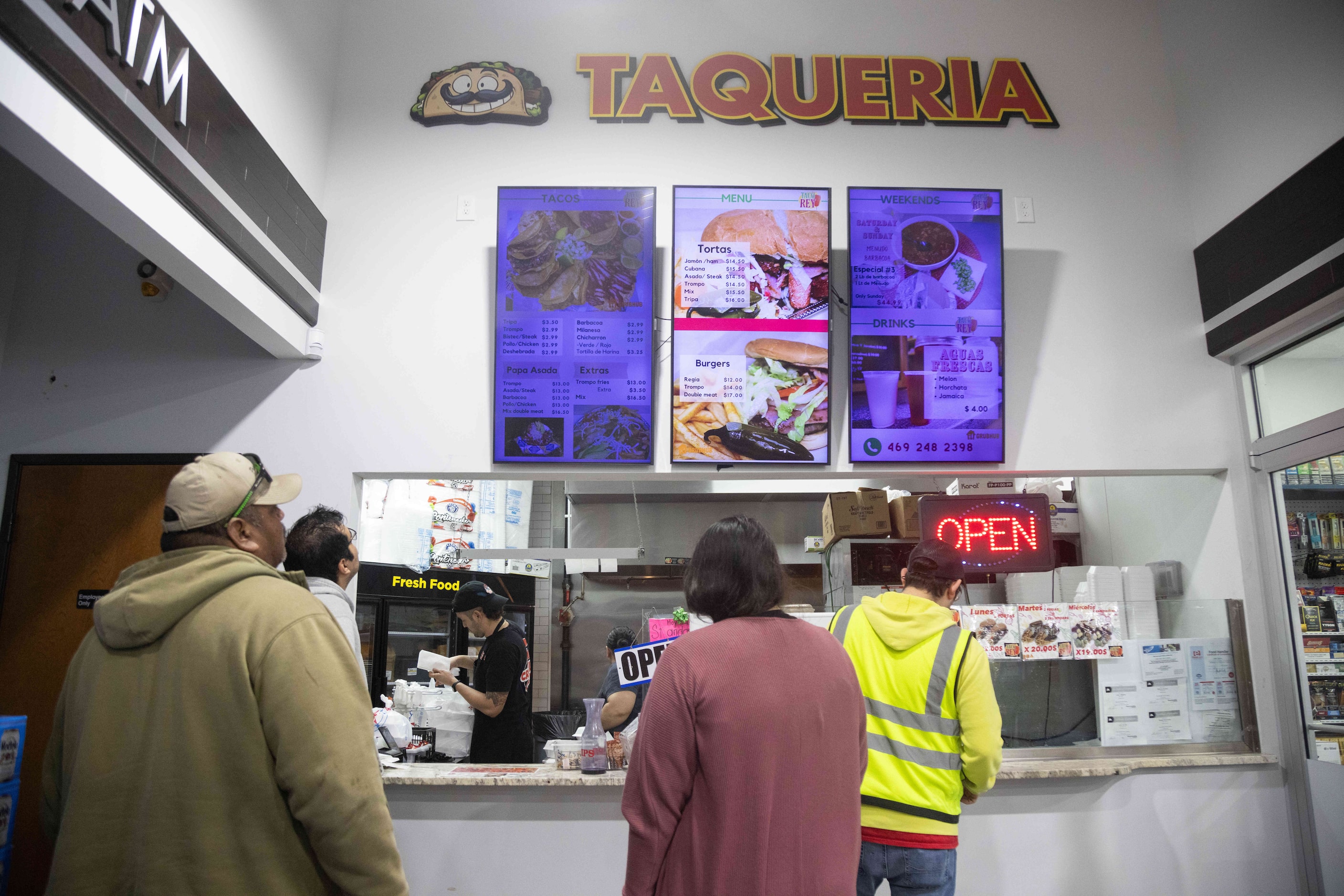 People wait to order at Taco Rey (Polkmart), a popular taco shop inside a gas station at...