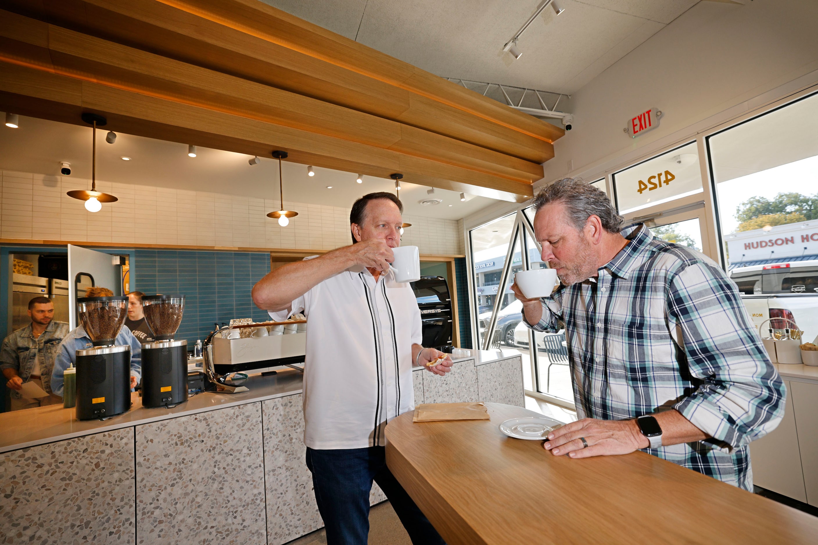 Kevin Pretzel of Lakewood neighborhood in Dallas, left, drinks coffee with Charlie Paulette,...