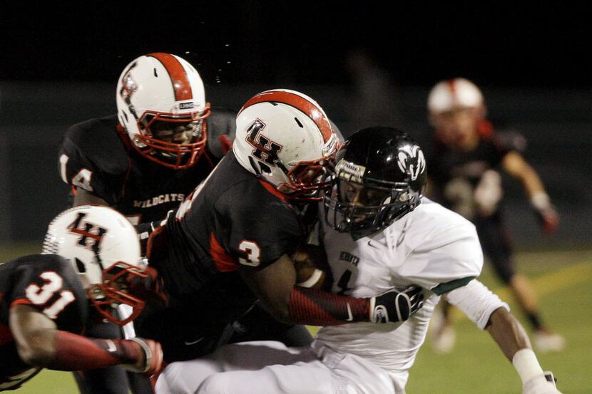 Richardson Berkner quarterback Louis Yedidiah (1) took a hard hit from Lake Highlands' Ben...