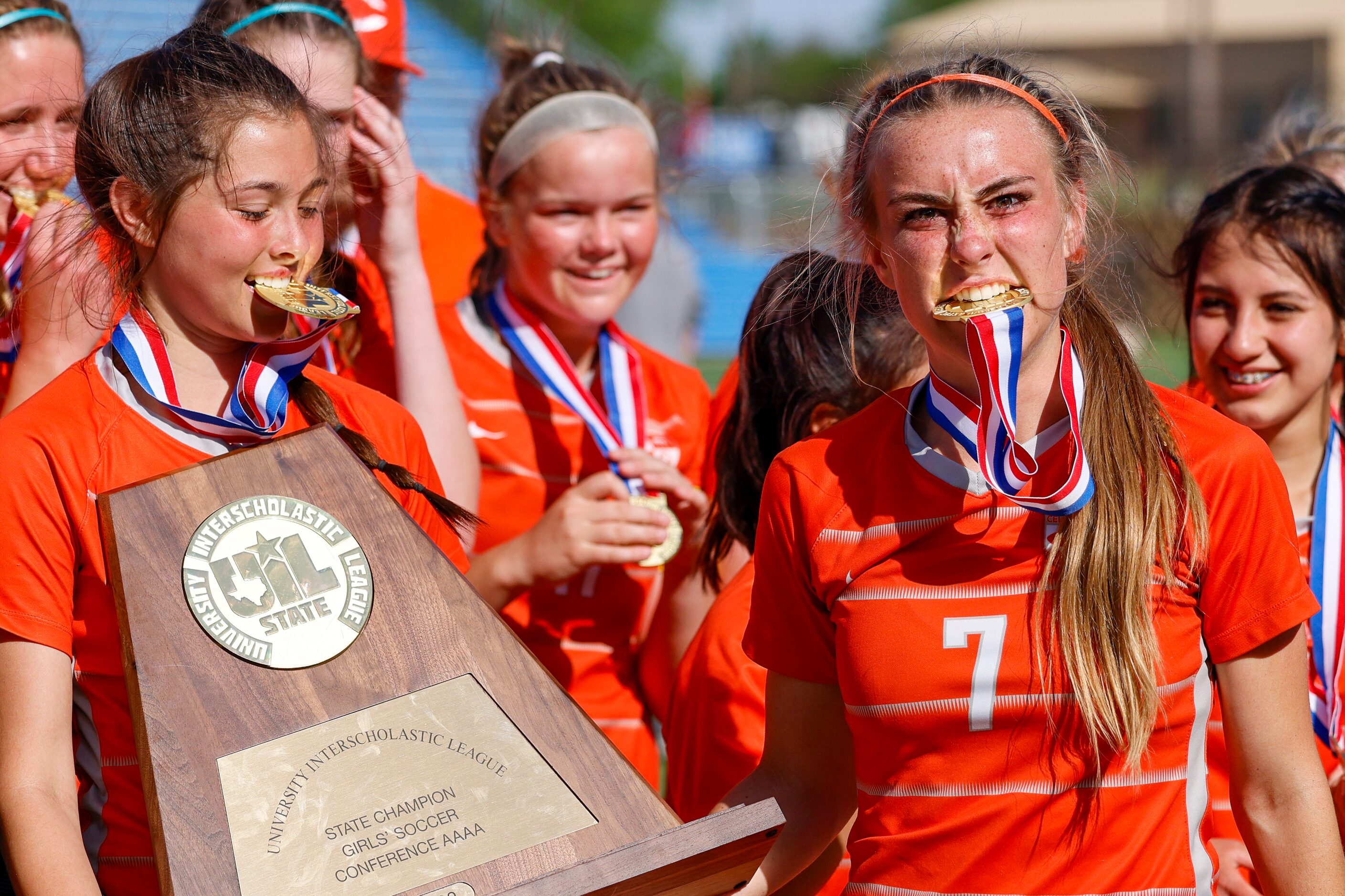 Celina midfielder Lexi Tuite (7) bites her state championship medal as Celina defender...