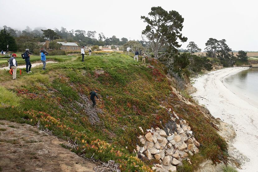 PEBBLE BEACH, CA - AUGUST 19: Viktor Hovland of Norway climbs down an embankment to play his...