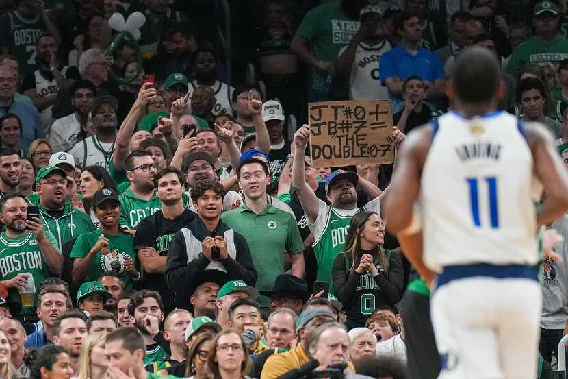 Boston Celtics fans chant “Kyrie Sucks” toward Dallas Mavericks guard Kyrie Irving (11)...