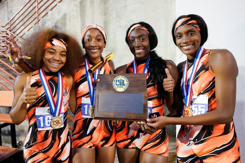 Te winning Lancaster girls 4X200 relay team poses with their trophy at the 5A UIL State...