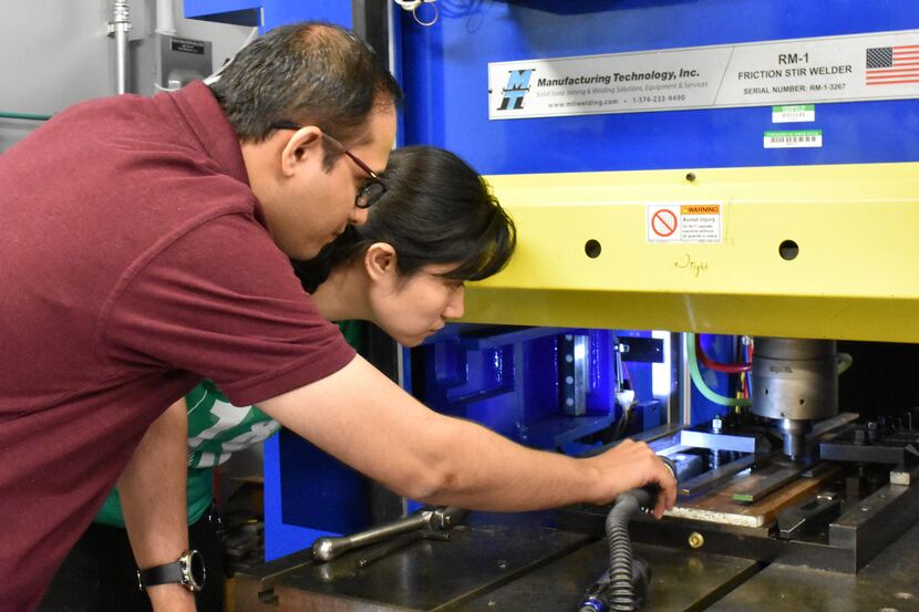 Researcher Dr. Saurabh Nene works with research assistant Kaimiao Liu using a "friction...