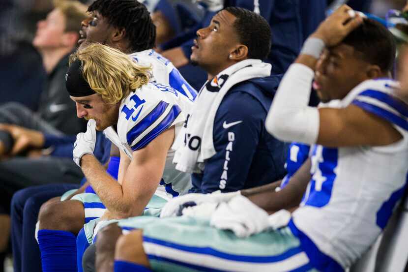 Dallas Cowboys wide receiver Cole Beasley (11), left, and Terrance Williams (83) sit on the...