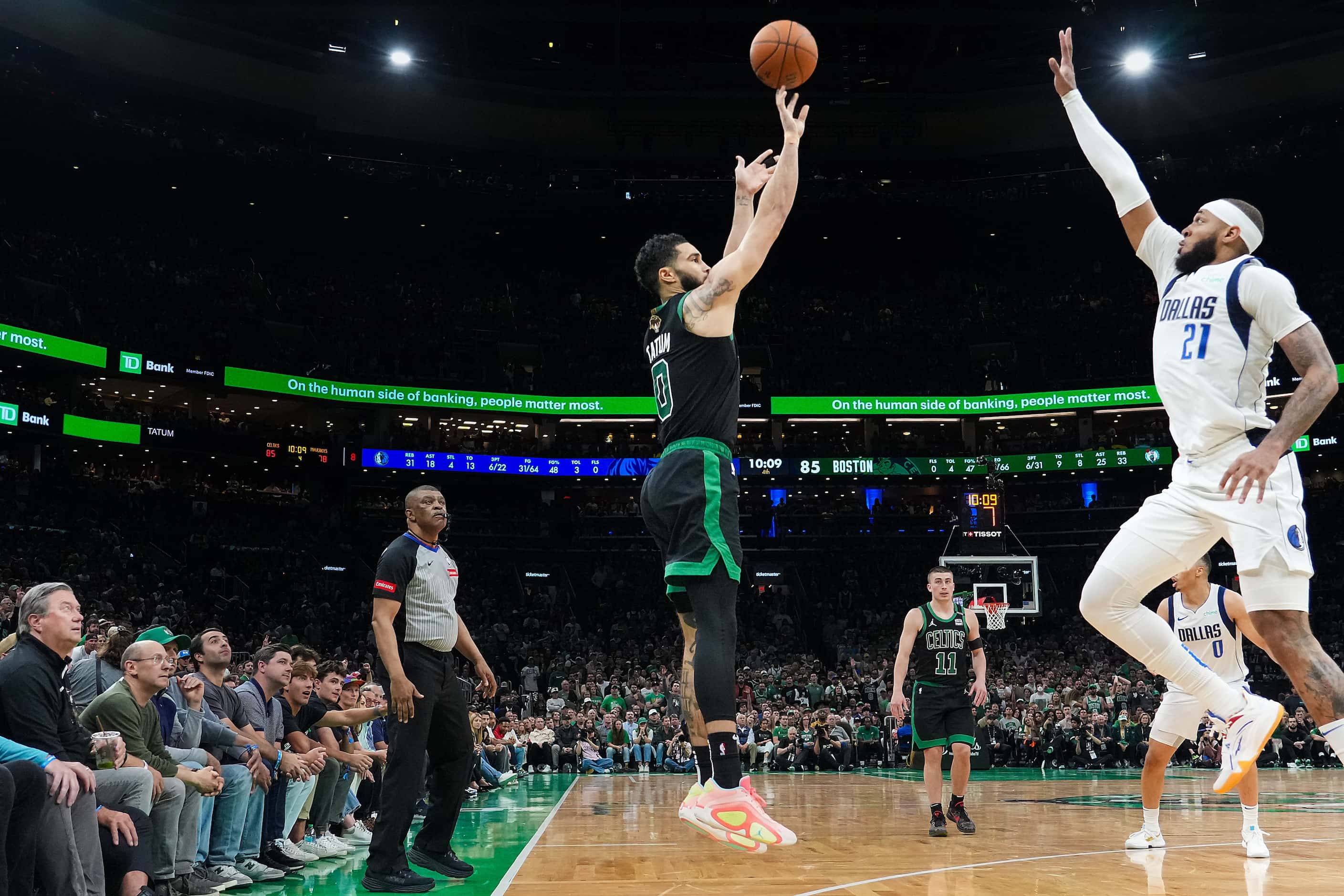 Boston Celtics forward Jayson Tatum (0) hits a 3-pointer over Dallas Mavericks center Daniel...