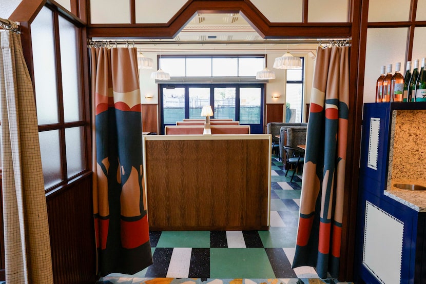 Curtains separate a dining room and the order-at-the-counter bar of The Meteor in Dallas.