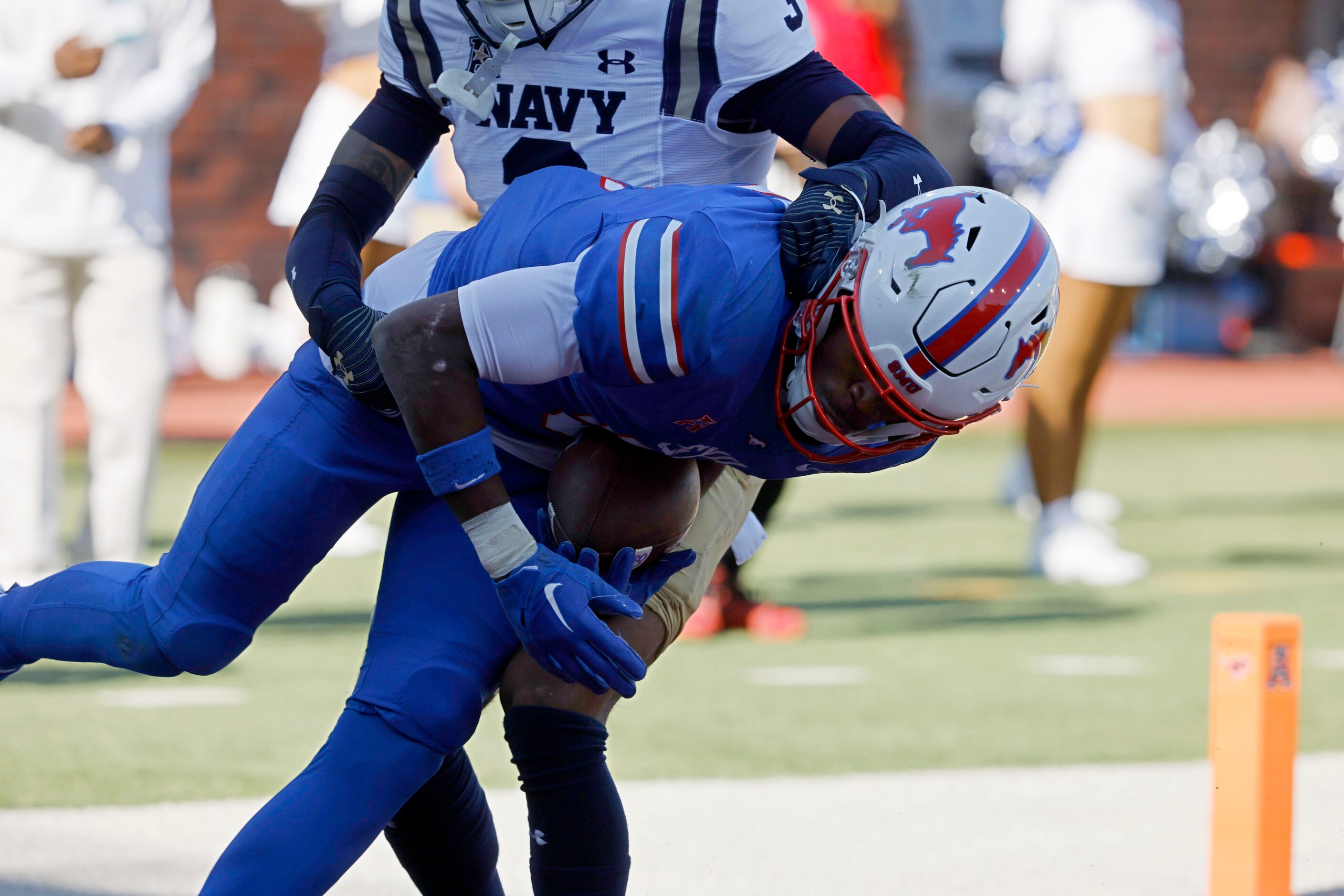 SMU wide receiver Moochie Dixon (5) scores a touchdown over Navy cornerback Elias Larry (3)...